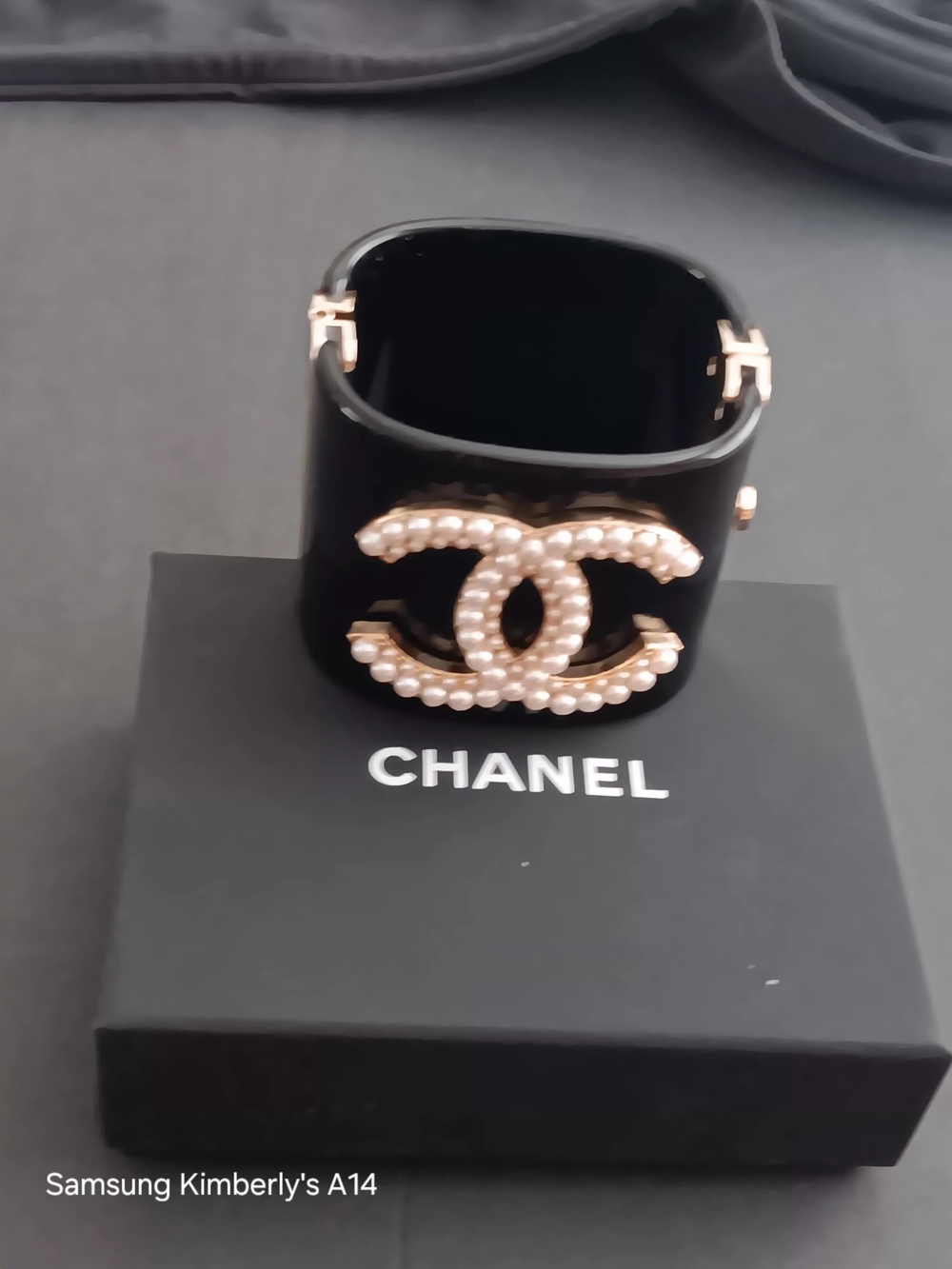 This item is a Chanel Pearl Logo Cuff Bracelet, typically crafted.